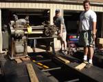 John and Mark using the engine hoist and ratchet straps to slide the lathe to the back of the trailer.